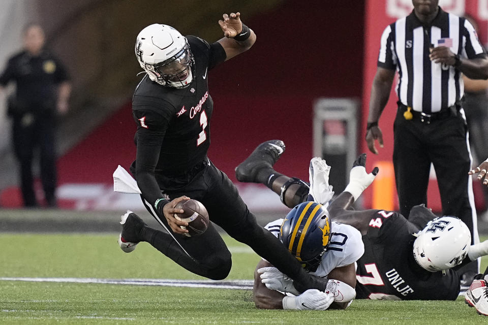 Houston quarterback Donovan Smith (1) is sacked by West Virginia linebacker Jared Bartlett (10) during the second quarter of an NCAA college football game Thursday, Oct. 12, 2023, in Houston. (AP Photo/Kevin M. Cox)