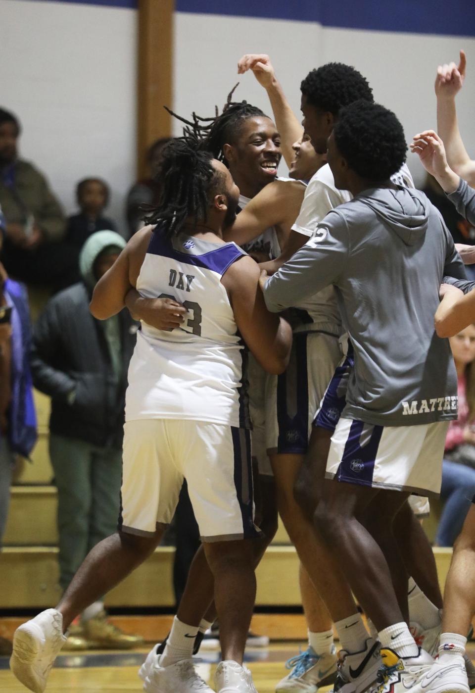 Reggie Smith Jr. smiles as he is congratulated by his teammates for scoring over 1,000 points during their game against Churchville-Chili at Brighton Central High School. He scored six points in the first few minutes of the first period.