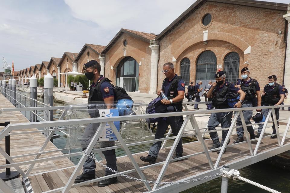 Policemen walk to embark on a boat at the Arsenale, during a G20 meeting of Economy and Finance ministers and Central bank governors in Venice, Italy, Thursday, July 8, 2021. (AP Photo/Luca Bruno)