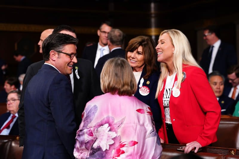 House Speaker Mike Johnson (L) chats with Rep. Marjorie Taylor Greene, R-Ga. (R), before President Joe Biden's 2024 State of the Union speech to a joint session of Congress on March 7. Greene is taking steps to remove Johnson from the speakership. File Pool Photo by Shawn Thew/UPI