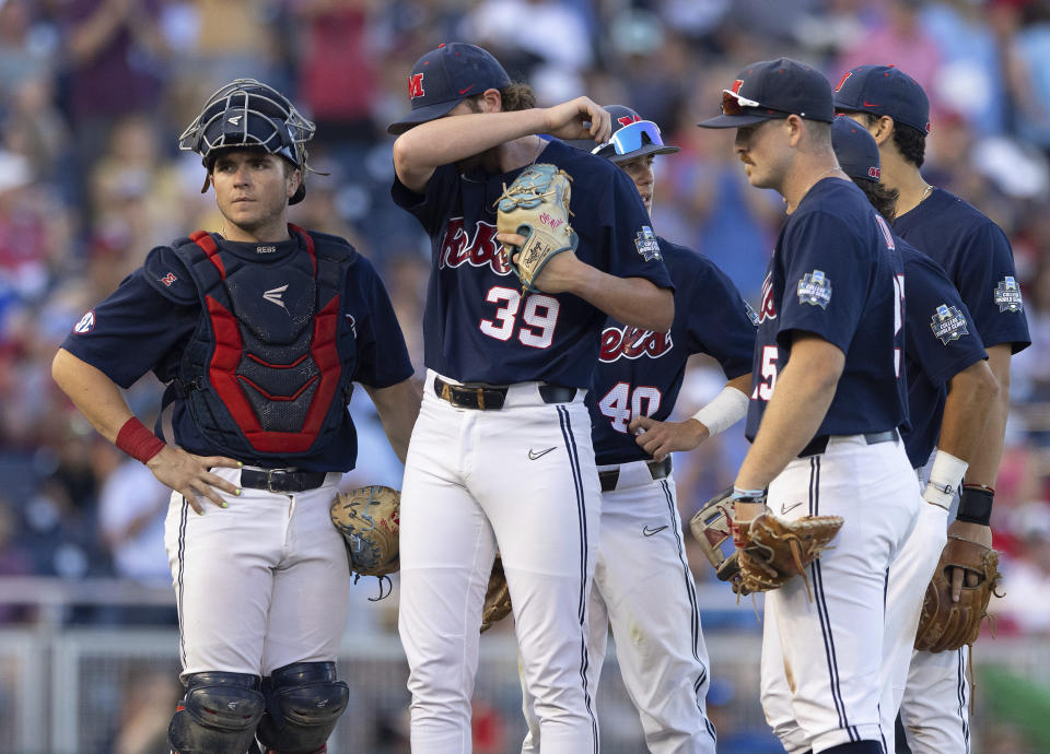 Mississippi starting pitcher Jack Dougherty (39) wipes his brow as he awaits his reliever on the mound after Oklahoma loaded the bases in the sixth inning during the first championship baseball game of the NCAA College World Series, Saturday, June 25, 2022, in Omaha, Neb. (AP Photo/Rebecca S. Gratz)