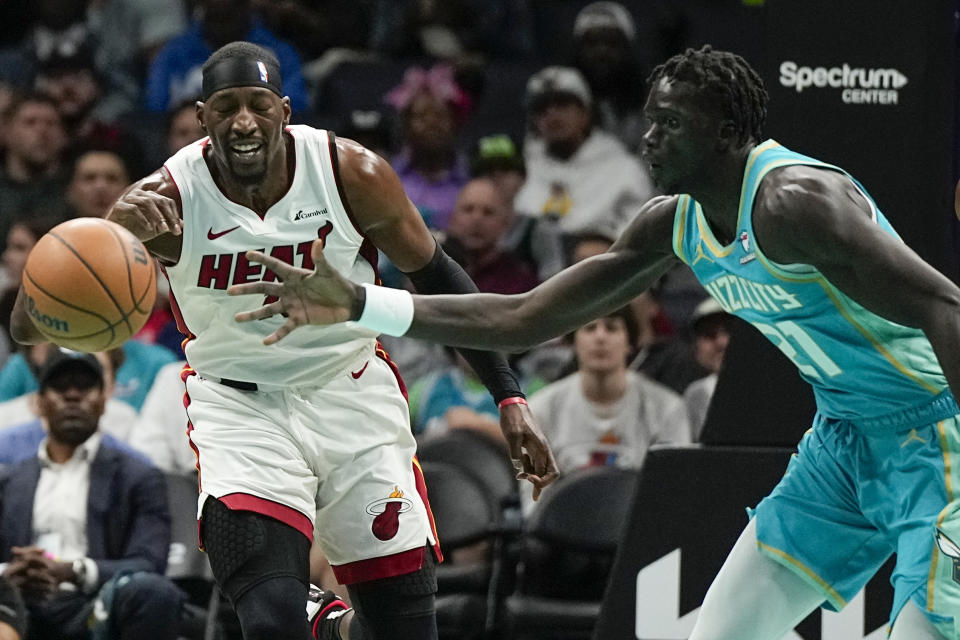 Miami Heat center Bam Adebayo and Charlotte Hornets forward JT Thor chase a loose ball during the first half of an NBA basketball game on Tuesday, Nov. 14, 2023, in Charlotte, N.C. (AP Photo/Chris Carlson)