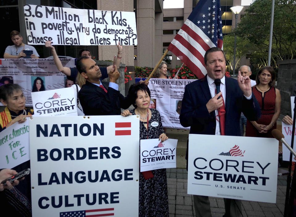 Stewart, right, speaks before a group of about 35 supporters in front of an Immigration and Customs Enforcement office in Fairfax, Va. (Photo: Michael S. Williamson/The Washington Post)