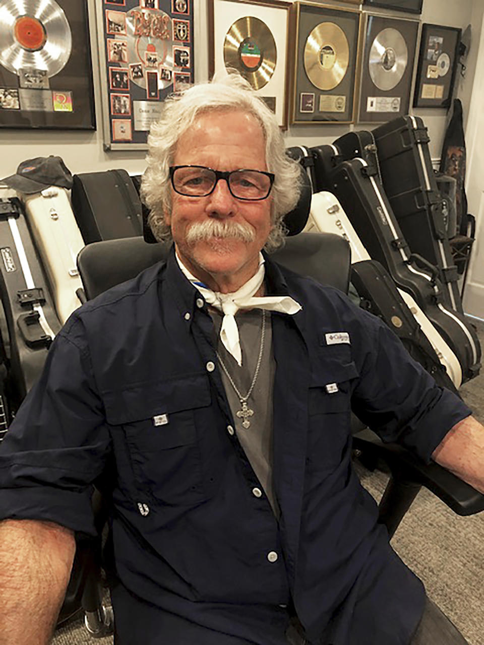 Chris Hillman, a founding member of the Byrds and Flying Burrito Brothers, and one of the architects of country-rock and folk-rock, appears in his home office in Ventura, Calif., on Dec. 3, 2020. Hillman published a memoir, "Time Between: My Life as a Byrd, Burrito Brother and Beyond," revealing what it was like rising to rock 'n' fame in the '60s and the triumphs and tragedy that he witnessed. (Connie Pappas HIllman via AP)