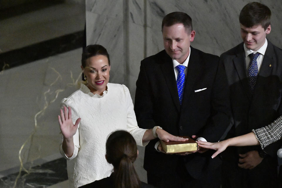 Kentucky Lt. Gov. Jacqueline Coleman takes the oath of office from Judge Cole Adam Maier as her husband, Chris O'Bryan, holds the Bible, in the Capitol Rotunda in Frankfort, Ky., early Tuesday, Dec. 12, 2023. (AP Photo/Timothy D. Easley)
