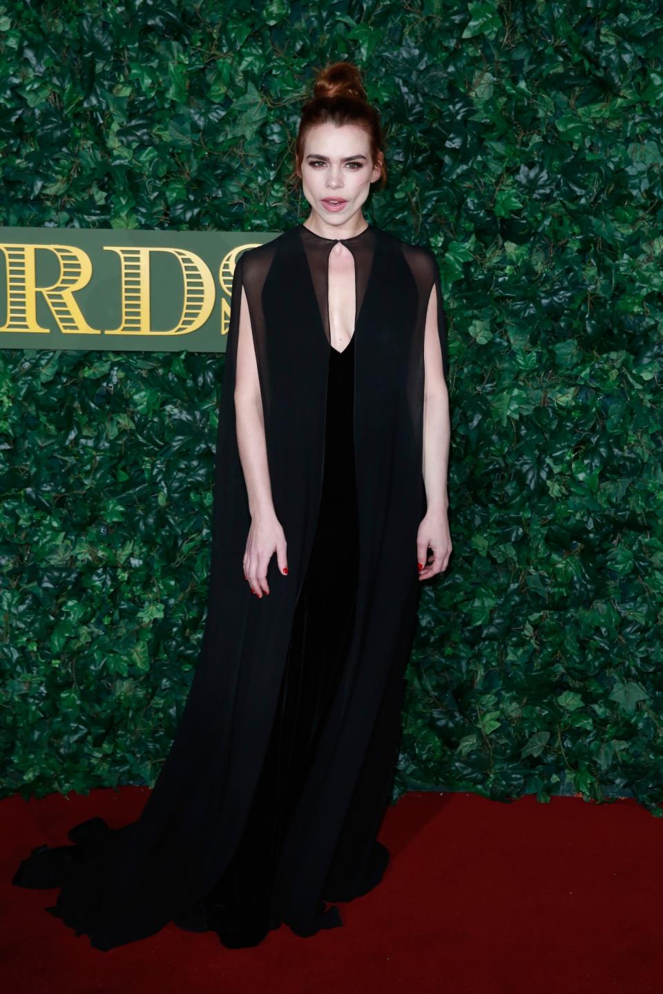 <p>Billie Piper's super long black dress gave off a gothic vibe with its cape detail. It worked perfectly with her porcelain skin and auburn up do. <i>[Photo: Getty]</i> </p>