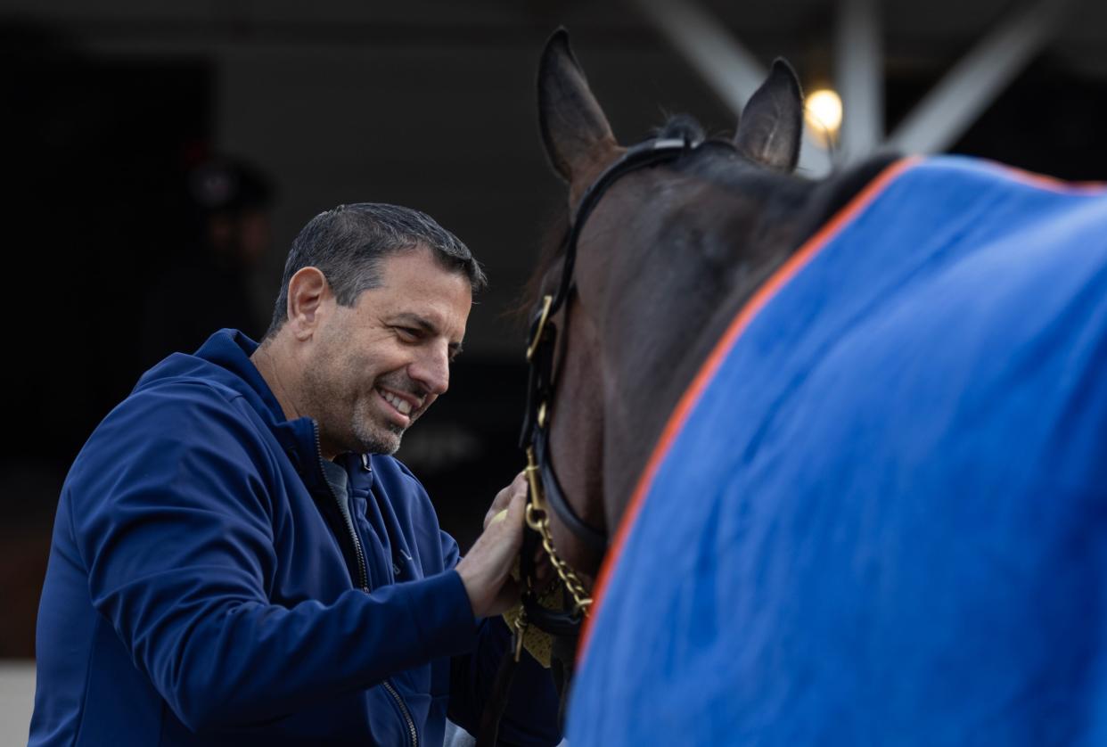 Owner Mike Repole interacts with his horse, Kentucky Derby favorite, Fierceness, on the backside of Churchill Downs.