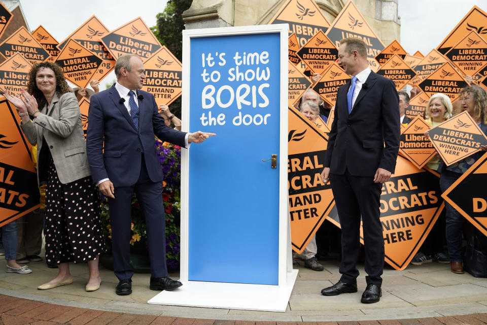 Liberal Democrat Chief Whip Wendy Chamberlain, left, and Liberal Democrat Leader Ed Davey, left, celebrates with Richard Foord, right, the newly-elected Liberal Democrat lawmaker for Tiverton and Honiton, in Crediton, England, Friday June 24, 2022. British Prime Minister Boris Johnson suffered a double blow as voters rejected his Conservative Party in two special elections dominated by questions about his leadership and ethics. The centrist Liberal Democrats overturned a big Conservative majority to win the rural south west England seat of Tiverton and Honiton, while the main opposition Labour Party reclaimed Wakefield in northern England from Johnson's Tories. (Andrew Matthews/PA via AP)