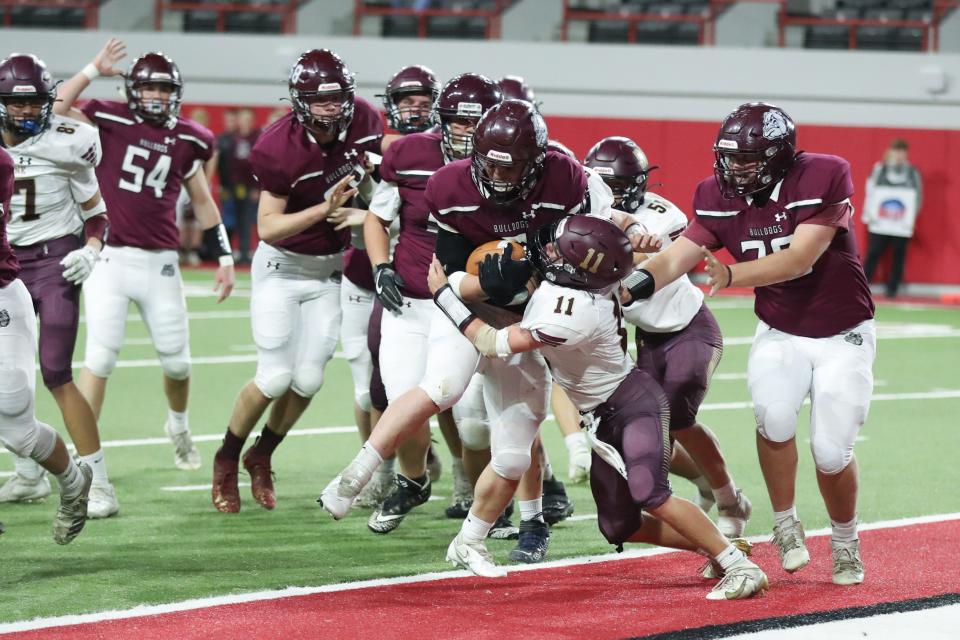 Madison Bulldogs RB Trey Smith (5) drives his way into the endzone against the Milbank Bulldogs Friday at the Dakota Dome. Madison won 31-0.