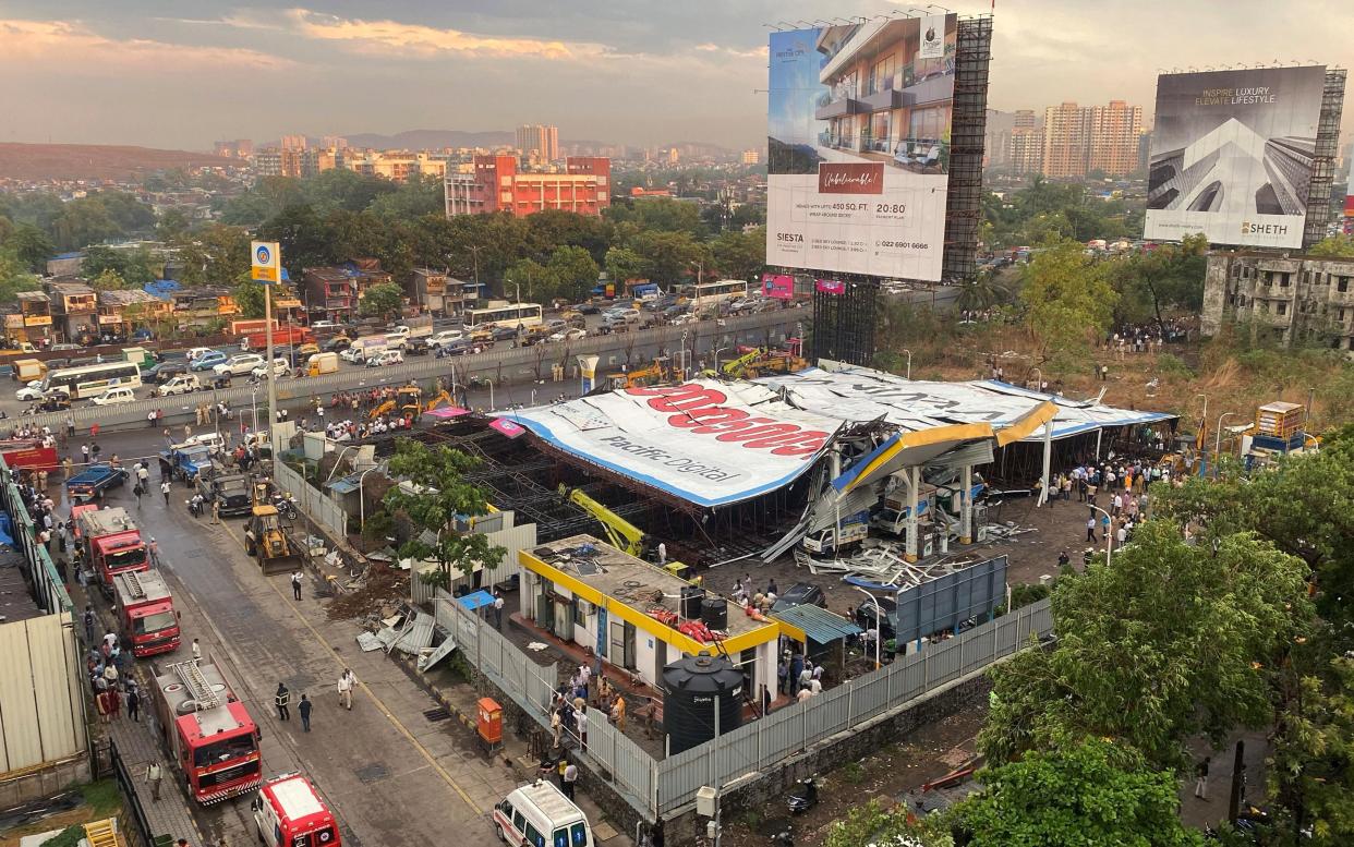 An aerial view shows a fallen billboard on a fuel station following a wind and dust storm in Mumbai, India, May 13, 2024.