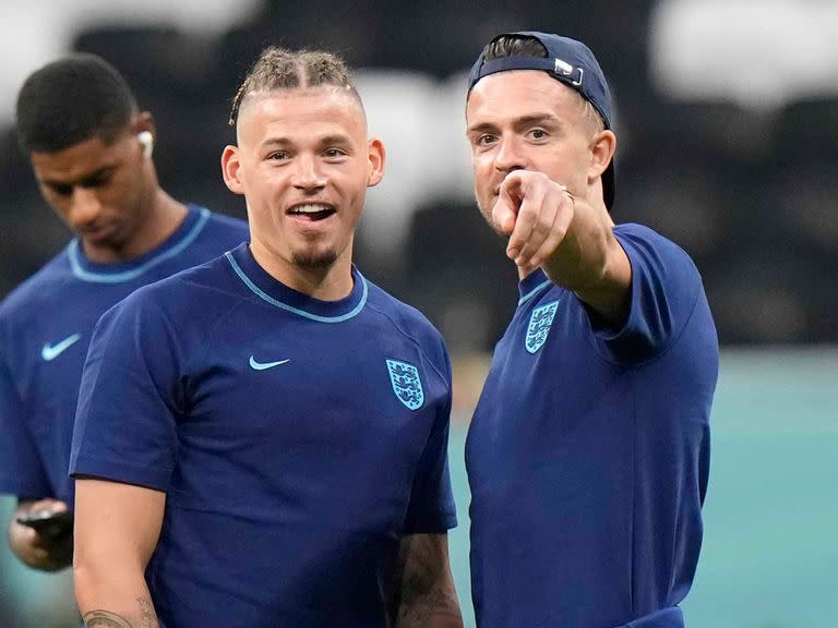 England's Kalvin Phillips, center left, and Jack Grealish have a chat on the pitch ahead of the World Cup group B soccer match between England and The United States, at the Al Bayt Stadium in Al Khor , Qatar, Friday, Nov. 25, 2022. (AP Photo/Luca Bruno)