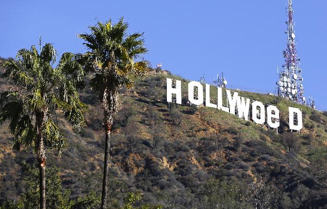 FILE - In this Sunday, Jan. 1, 2017, file photo, the Hollywood sign is seen vandalized. Los Angeles residents awoke New Year's Day to find a prankster had altered the famed Hollywood sign to read "HOLLYWeeD." Police have also notified the city's Department of General Services, whose officers patrol Griffith Park and the area of the rugged Hollywood Hills near the sign. California voters in November approved Proposition 64, which legalized the recreational use of marijuana, beginning in 2018. (AP Photo/Damian Dovarganes, File)