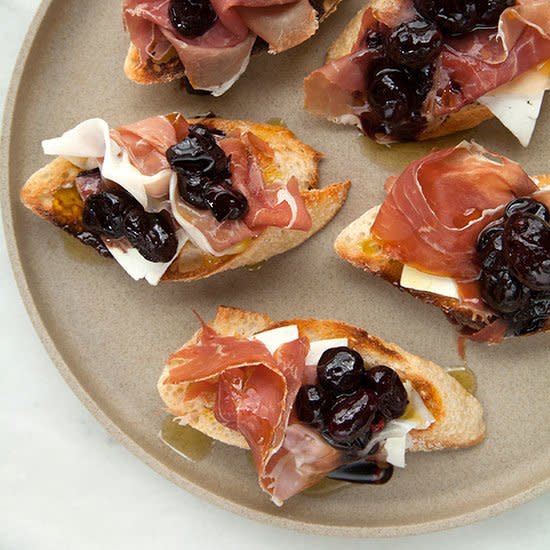 Crostini with Stewed Black Grapes, Prosciutto and Ricotta Salata