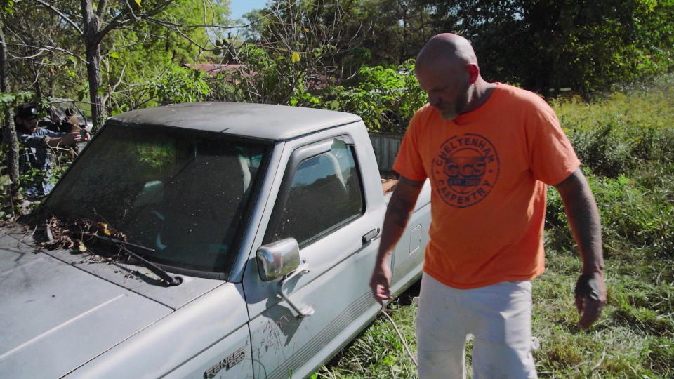 Michael Politte with his mother's truck. He and his sisters hope to fix it up and get it running again. / Credit: CBS News