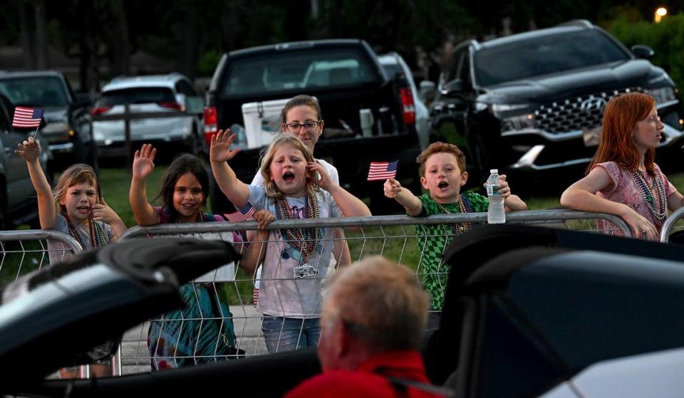 Young children scream for beads during the DeSoto Parade on Saturday, April 27, 2024.