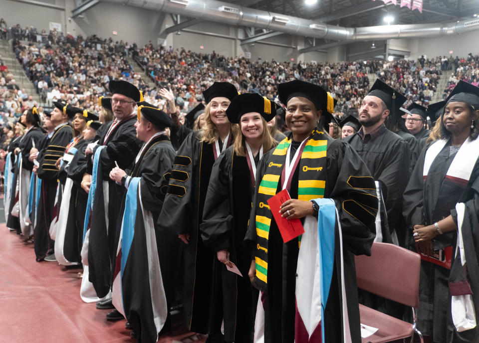 Doctoral graduates are all smiles at the WT commencement ceremony Saturday morning at the First United Bank Center in Canyon.