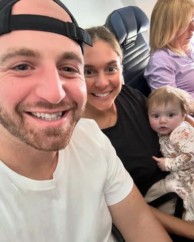 <p>Courtesy of Kelly Levine</p> Kelly Levine with her husband Jake and daughter Romey on the plane