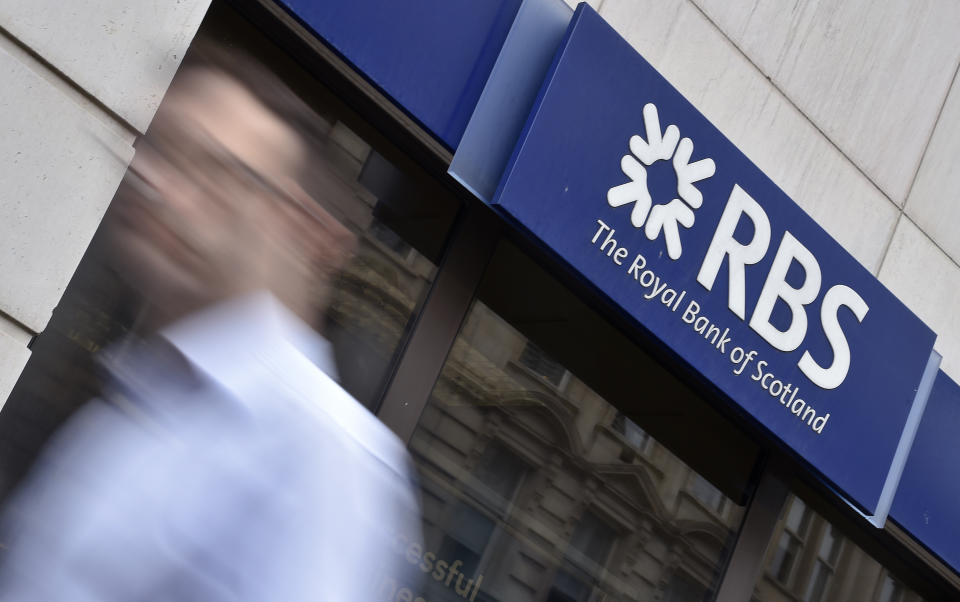 A man walks past a branch of The Royal Bank of Scotland (RBS) in central London August 27, 2014. REUTERS/Toby Melville/File Photo