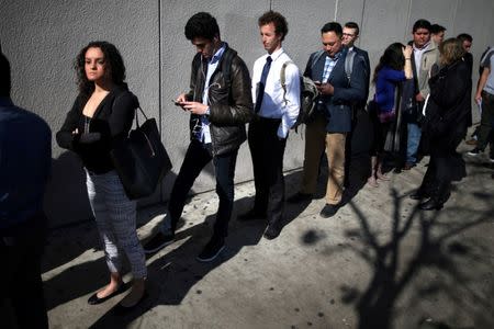 FILE PHOTO: People wait in line to attend TechFair LA, a technology job fair, in Los Angeles, California, U.S., January 26, 2017. REUTERS/Lucy Nicholson