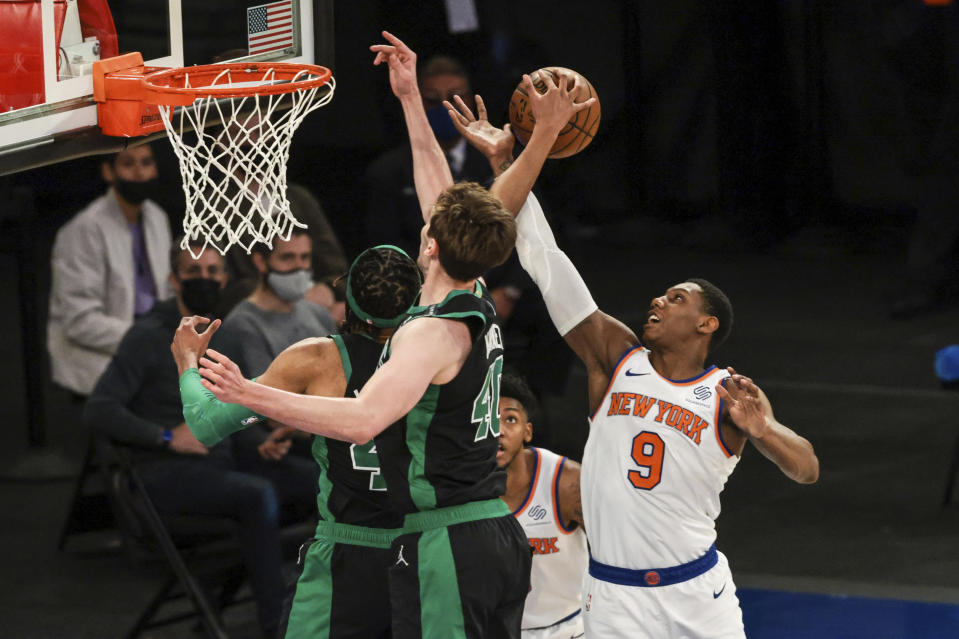 Boston Celtics center Luke Kornet (40) battles for the ball against New York Knicks guard RJ Barrett (9) during the second half of an NBA basketball game in New York, Sunday, May 16, 2021. (Vincent Carchietta/Pool Photo via AP)