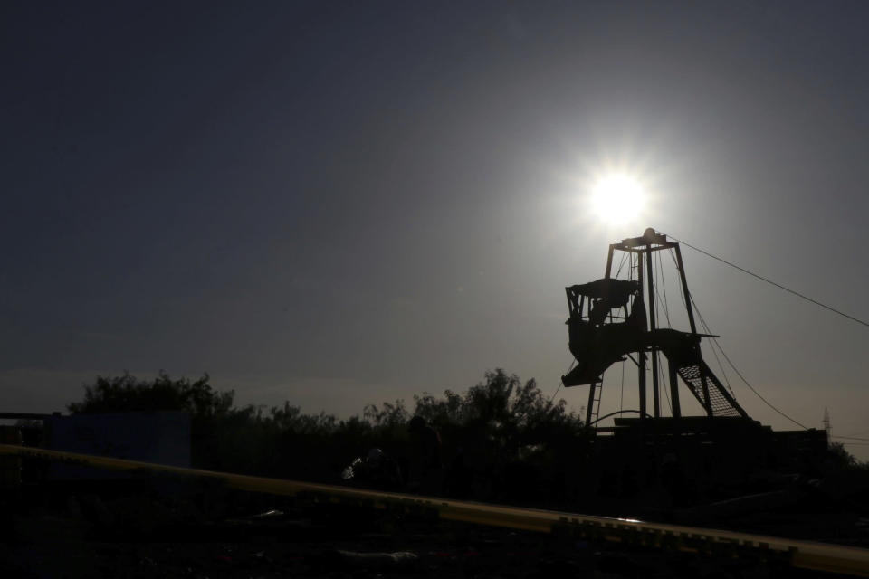 The sun set behind a tower that is used by the the rescue team to enter to the mine where miners are trapped in a collapsed and flooded coal mine in Sabinas, Coahuila state, Mexico, Thursday, Aug. 4, 2022. The collapse occurred after the miners breached a neighboring area filled with water on Wednesday, officials said. (AP Photo/Alfredo Lara)