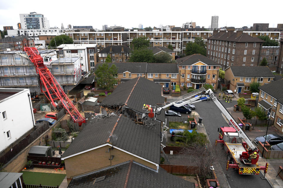 BOW, ENGLAND - JULY 08: Emergency crews at the scene where a 20-metre crane collapsed on onto a terraced house in East London on July 8, 2020 in Bow, England. The London Fire Brigade are working to rescue people trapped in a terraced house after a 20-meter crane on a nearby building site has collapsed. (Photo by Chris J Ratcliffe/Getty Images)