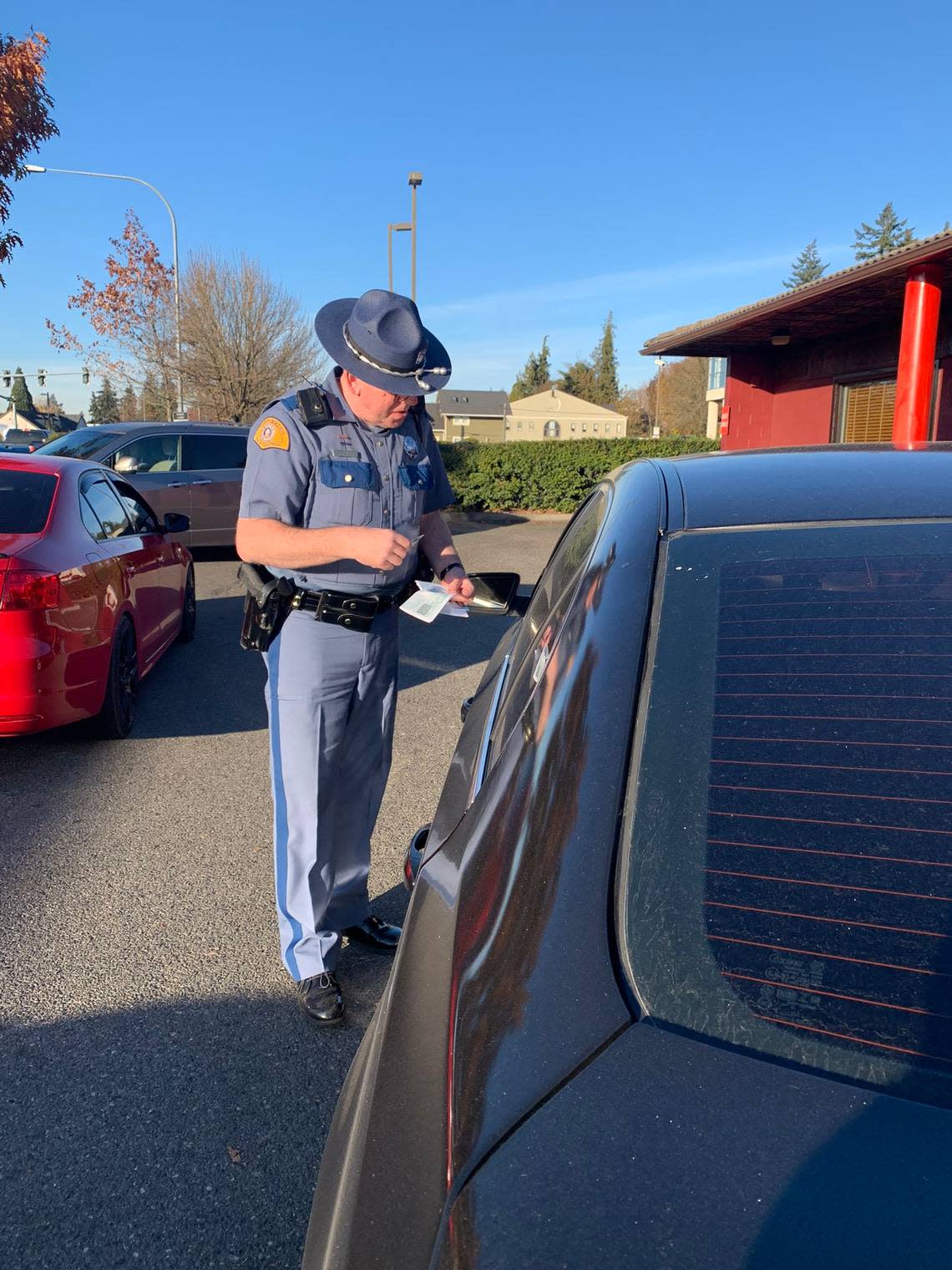 A Washington State Patrol trooper conducts a traffic stop in Pierce County on Saturday, Nov. 19, as part of an emphasis patrol.