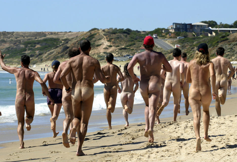 Rear view of Streakers competing in the marathon event during the 30th annual Nude Olympics on Maslin Beach near Adelaide, 23 January 2005