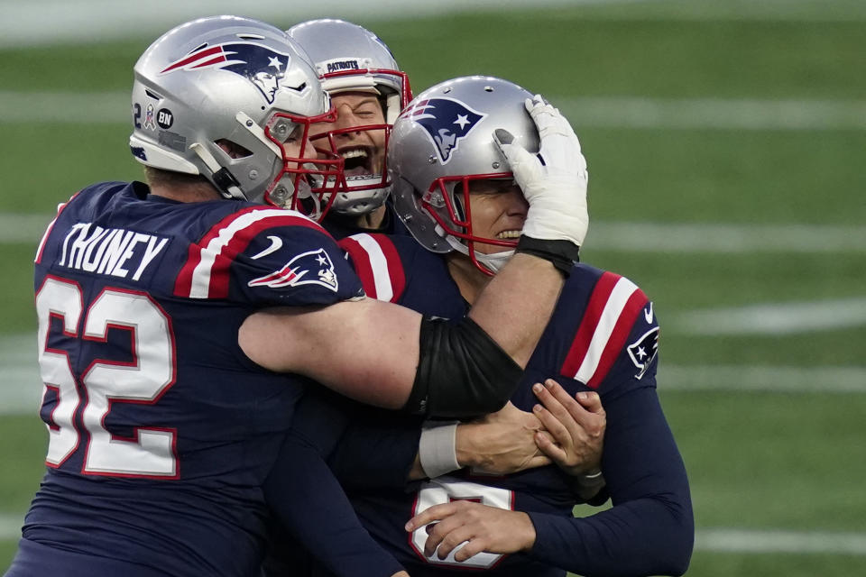 New England Patriots kicker Nick Folk celebrates his game-winning field goal with lineman Joe Thuney, left, and holder Jake Bailey, rear, as time expires in an NFL football game against the Arizona Cardinals, Sunday, Nov. 29, 2020, in Foxborough, Mass. (AP Photo/Elise Amendola)