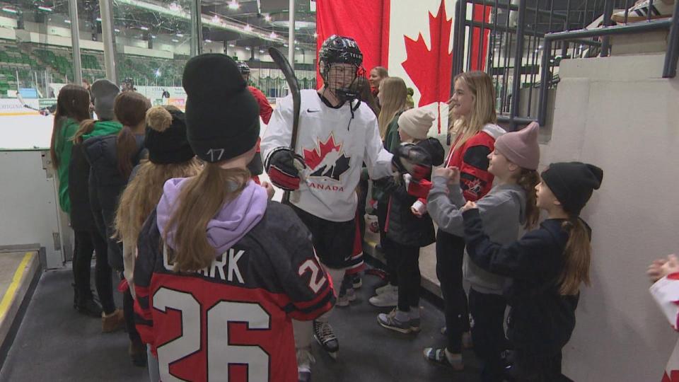 Though most of the stands were empty, girls and boys watched the red-and-white clad players — many with their faces all but pressed to the glass — and greeted them on their way back to the dressing room. Some wore Emily Clark's jersey.