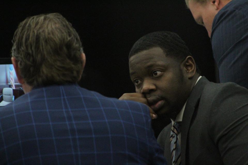 Othal Wallace looks toward one of his defense attorneys on Tuesday. Wallace is on trial in Clay County charged with first-degree murder in the killing of Daytona Beach police officer Jason Raynor.