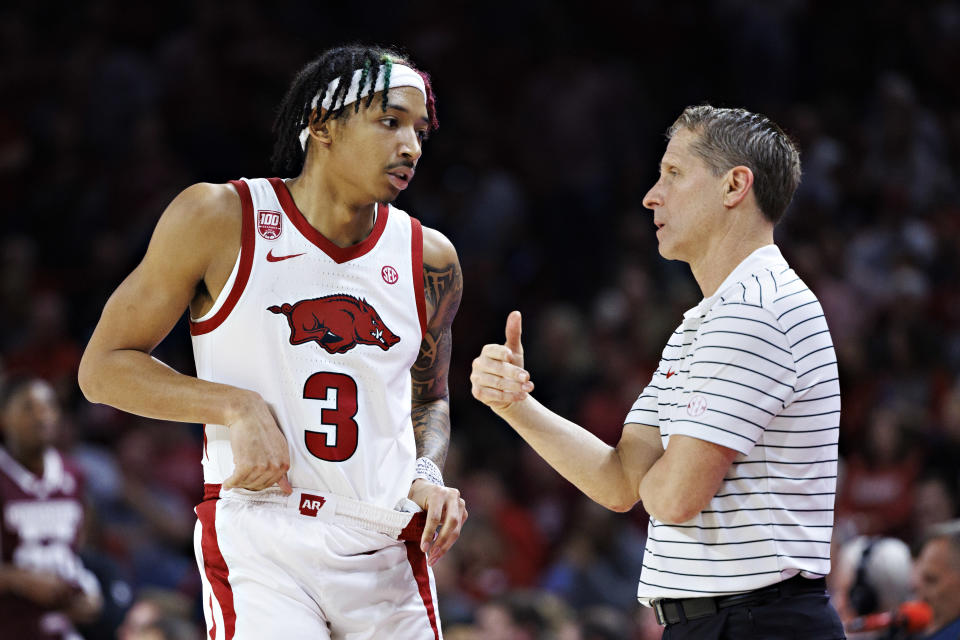 Arkansas guard Nick Smith Jr. and coach Eric Musselman talk during a game against Mississippi State on Feb. 11. (Wesley Hitt/Getty Images)