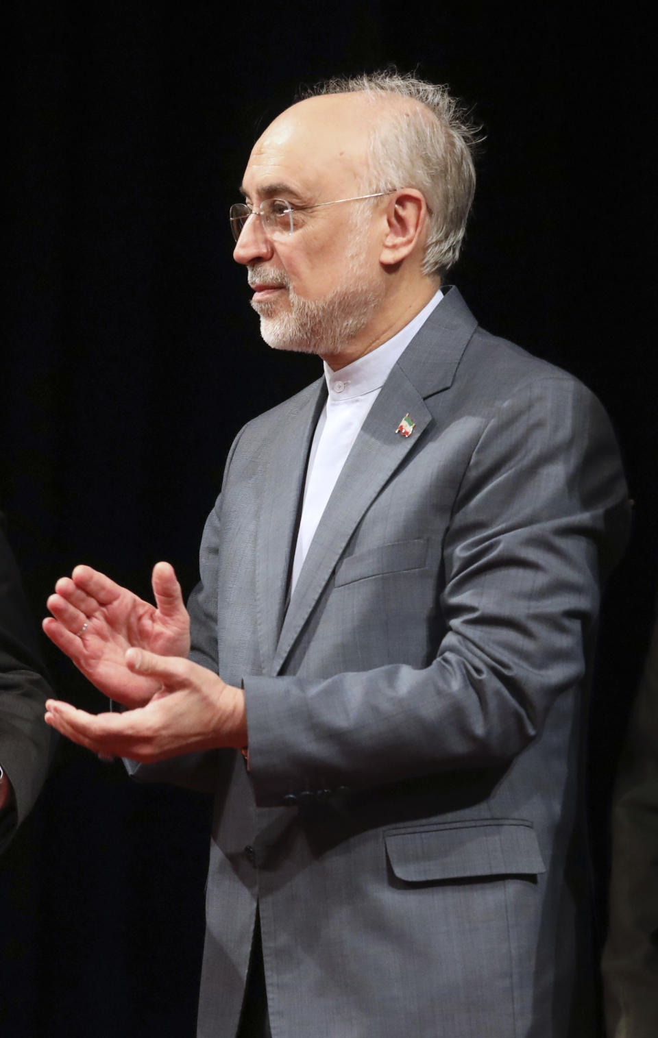 Head of the Atomic Energy Organization of Iran Ali Akbar Salehi applauds at the Mustafa scientific award ceremony, in Tehran, Iran, Monday, Nov. 11, 2019. Salehi told The Associated Press that Iran is now producing more low-enriched uranium daily after restarting an underground lab. Salehi made the comments on Monday as Iranian President Hassan Rouhani also called on hard-liners to support the country's troubled nuclear deal as it could open up international arms sales for the Islamic Republic next year. (AP Photo/Vahid Salemi)
