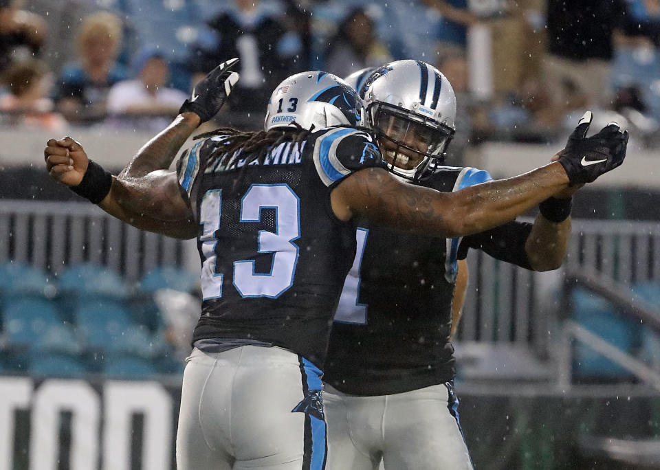 Panthers QB Cam Newton, right, celebrates after throwing a touchdown pass to WR Kelvin Benjamin against the Jaguars on Thursday. (AP)