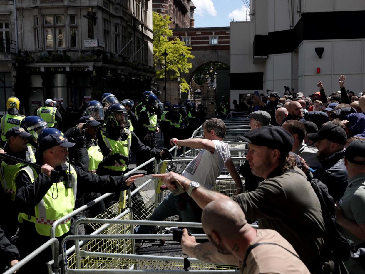 A man kicks a barrier as activists from far-right linked groups clash with police on Parliament Street, in London, on 13 June 2020: Dan Kitwood/Getty Images