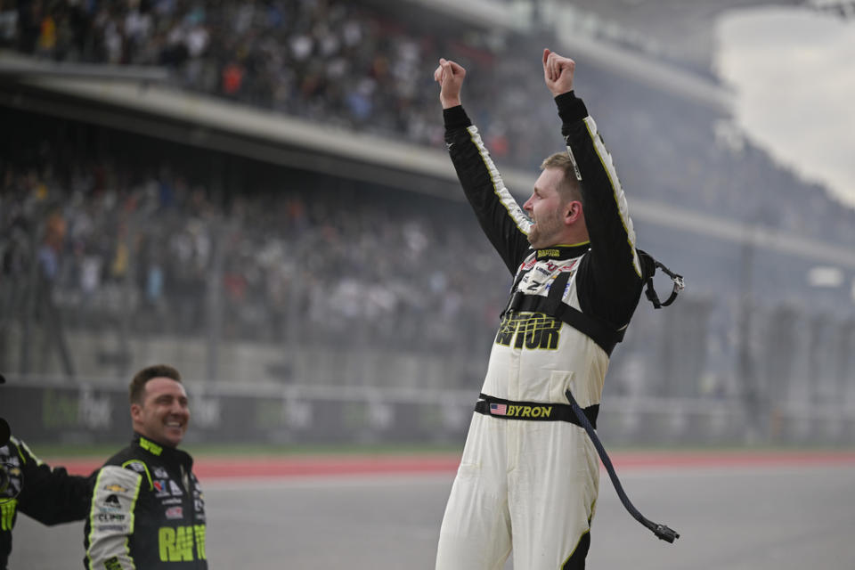 William Byron, right, gestures to fans in celebration of his win after a NASCAR Cup Series auto race on Sunday, March 24, 2024, at Circuit of the Americas in Austin, Texas. (AP Photo/Darren Abate)