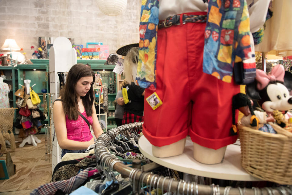 Leeah Peacock browses through a rack of clothing inside The Other Side Vintage Sunday, July 11, 2021. 