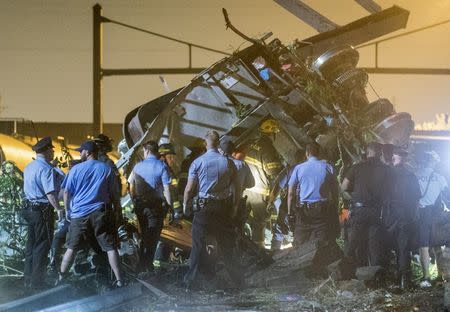 Rescue workers search for victims in the wreckage of a derailed Amtrak train in Philadelphia, Pennsylvania May 12, 2015. REUTERS/Bryan Woolston