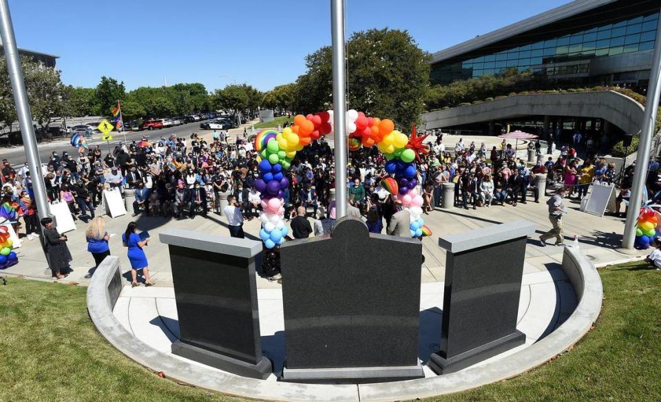 Crowds assemble before the raising of the LGBTQ+ Rainbow Pride flag over Fresno City Hall, Friday June 11, 2021.