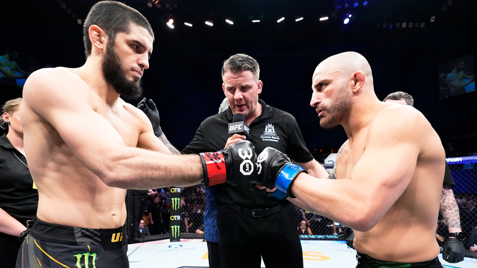 Islam Makhachev (pictured left) touching gloves with Alexander Volkanovski (pictured right).