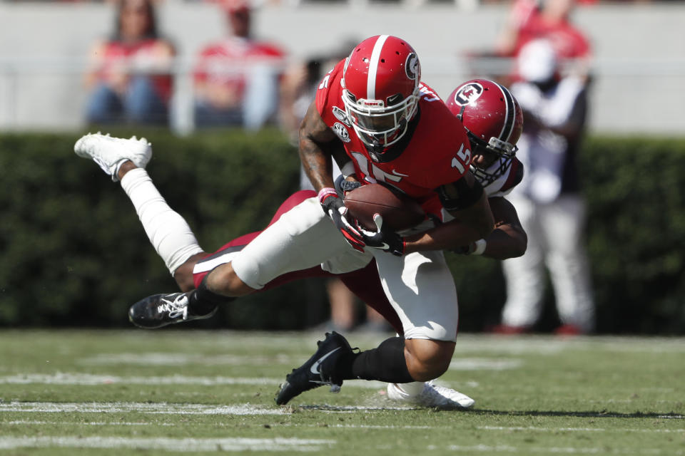 Georgia wide receiver Lawrence Cager (15) makes a catch as South Carolina defensive back Jaycee Horn (1) defends in the first half of an NCAA college football game Saturday, Oct. 12, 2019, in Athens, Ga. (AP Photo/John Bazemore)