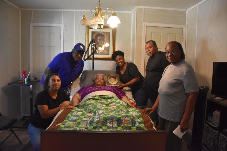 Members of Theresa Lang Brown's family surround her at her Effingham County home. Brown was among the survivors of the Feb. 3, 1971, explosion at Thiokol that killed 29 people.