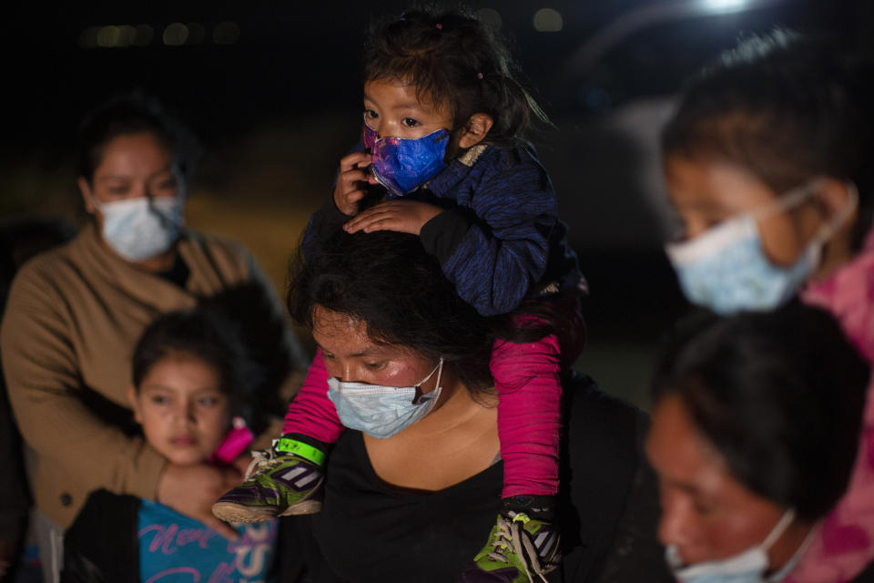 Migrant families coming from Guatemala, wait at a U.S. Border Patrol intake site after they were smuggled on an inflatable raft across the Rio Grande river in Roma, Texas, Wednesday, March 24, 2021. The Biden administration says that it's working to address the increase in migrants coming to the border. On Wednesday, President Joe Biden tapped Vice President Kamala Harris to lead the White House efforts at the U.S. southern border and work with Central American nations to address root causes of the migration. (AP Photo/Dario Lopez-Mills)