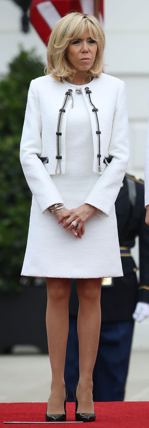 <p>At an arrival ceremony at the White House wearing a white dress and matching jacket with zipper detailing. </p>