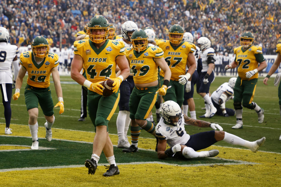 FILE - North Dakota State fullback Hunter Luepke (44) celebrates his touchdown against Montana State during the first half of the FCS Championship NCAA college football game in Frisco, Texas, on Jan. 8, 2022. South Dakota State and Sacramento State earned the top two seeds in the Football Championship Subdivision playoffs when the 24-team field was announced Sunday, Nov. 20, 2022. North Dakota State, the defending national champion and winners of nine of the last 11 titles, made the field for the 13th consecutive season. (AP Photo/Michael Ainsworth, File)