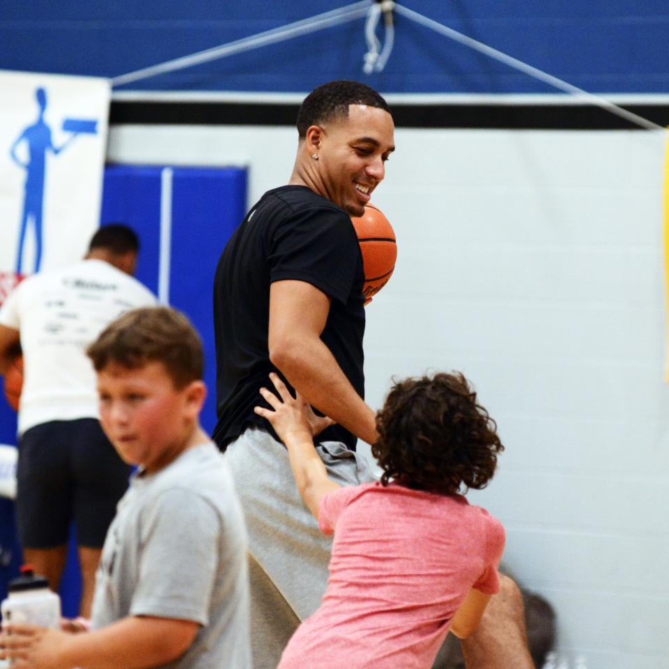 Former Zanesville High School standout Kevin Martin, who played for five teams in the NBA, horses around with nephew Kelby during his annual basketball camp at Zanesville Middle School in 2021.