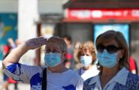 People hold a minute of silence in memory of those who died of the coronavirus disease (COVID-19), in Madrid