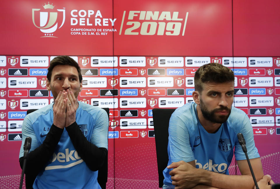 El delantero argentino Lionel Messi (izquierda) y el zaguero Gerard Piqué del Barcelona durante una rueda de prensa en la ciudad deportiva del club, el viernes 24 de mayo de 2019. El Barcelona enfrenta al Valencia en la final de la Copa del Rey el sábado. (AP Foto/Manu Fernández)