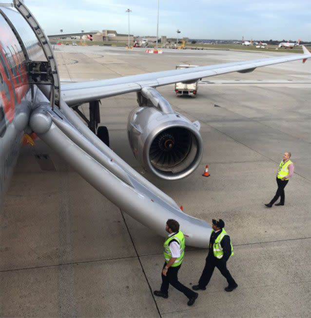 A passenger took photos of Jetstar officials inspecting the aircraft. Picture: Twitter/@flameoffirefoto
