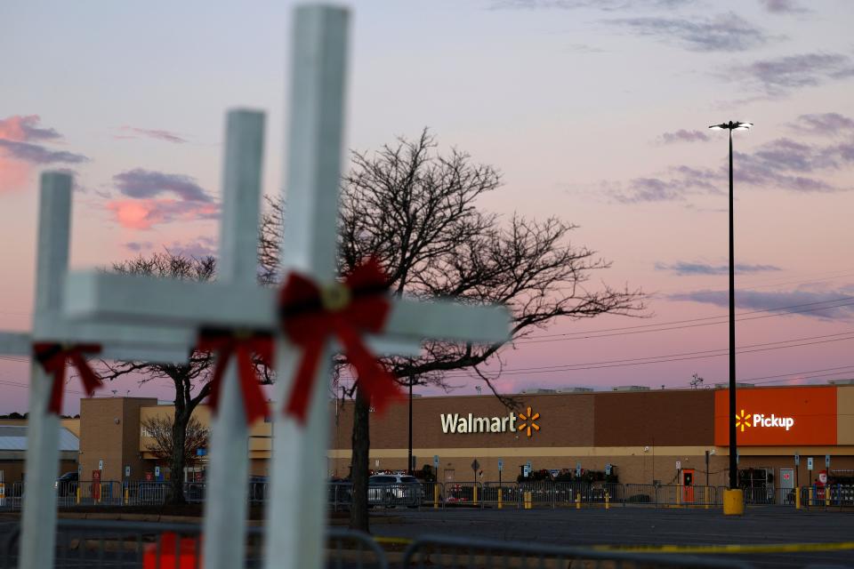 Balloons and wood crosses are placed in a parking lot near the site of a shooting at the Chesapeake Walmart Supercenter on Nov. 28, 2022 in Chesapeake, Virginia.